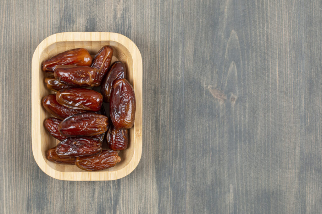 Fruits juicy dates wooden plate wooden table high quality photo scaled 1